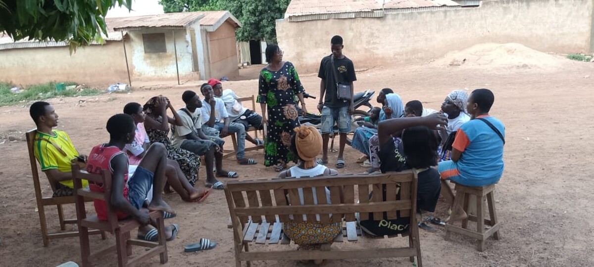 Group of young people gathered in a circle for an SRH awareness session
