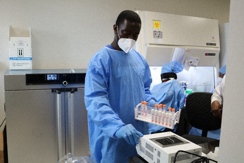 A member of staff at the Noguchi Memorial Institute for Medical Research in Accra, Ghana, is seen preparing a polymerase chain reaction test on June 18, 2020, in this image provided by the Japan International Cooperation Agency.